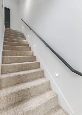 a living room with furniture kitchen view and a chandelier