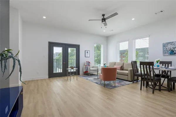 a living room with furniture wooden floor and a window