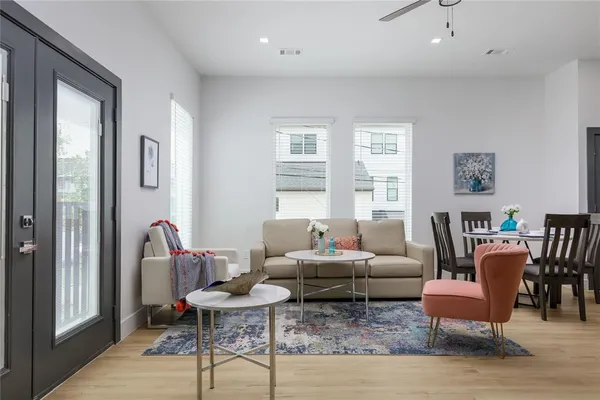 a living room with furniture kitchen and a table