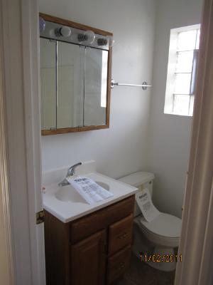 7418 West 63rd Place Summit, IL 60501 - Photo 7 of 9 a bathroom with a sink and a toilet