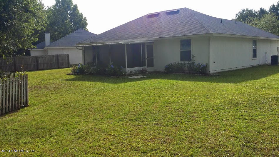 2750 Archer Street Middleburg, FL 32068 - Photo 13 of 34 a view of a house with a yard and a large tree