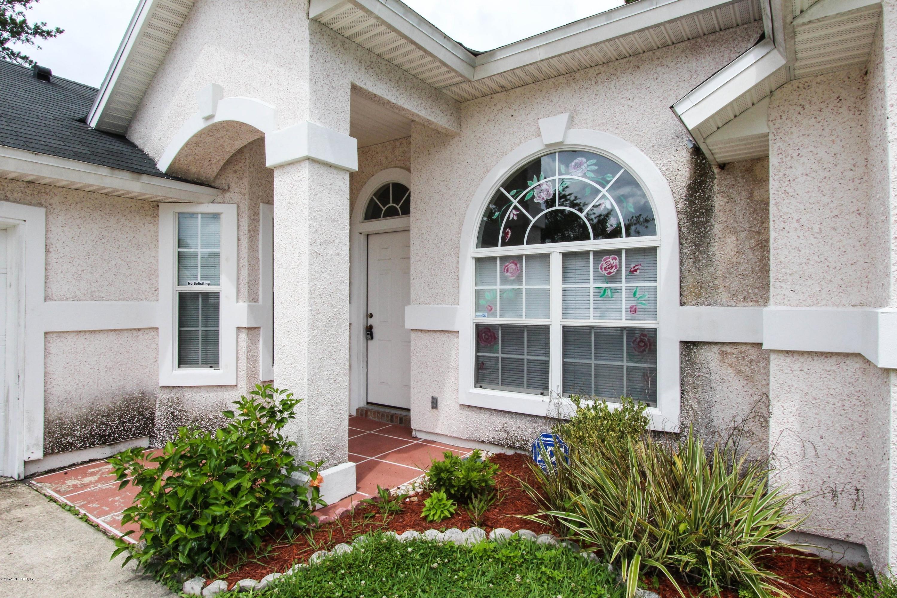 2750 Archer Street Middleburg, FL 32068 - Photo 15 of 34 a front view of a house with a garden