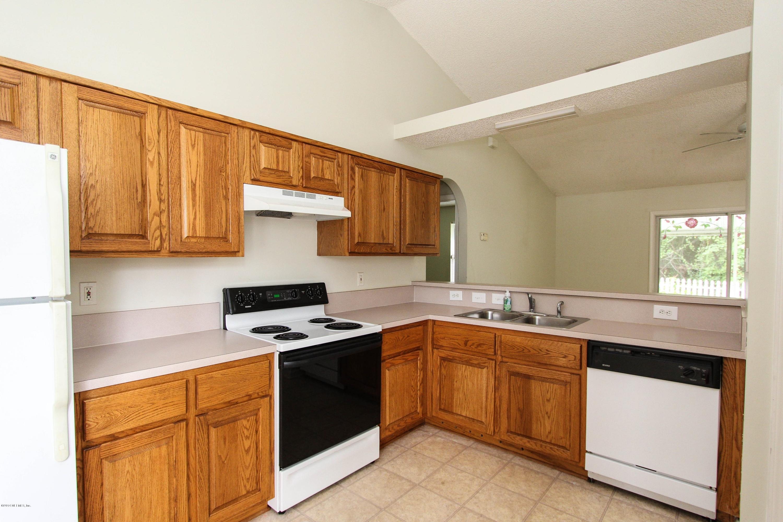 2750 Archer Street Middleburg, FL 32068 - Photo 20 of 34 a kitchen with stainless steel appliances granite countertop a sink stove and microwave