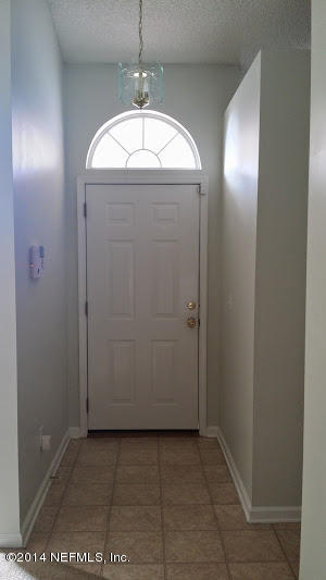 2750 Archer Street Middleburg, FL 32068 - Photo 2 of 34 an empty room with wooden floor cabinet and mirrors