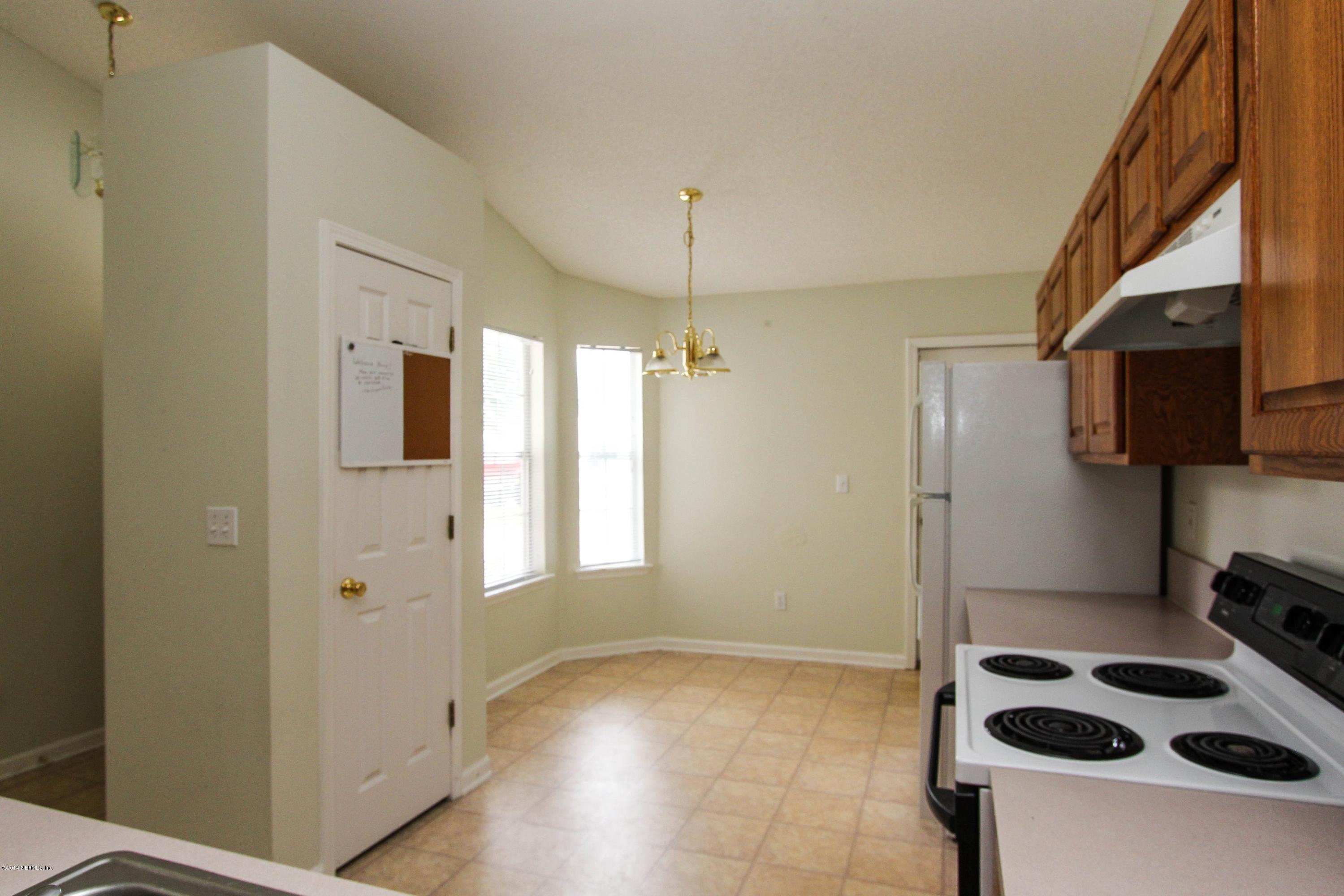 2750 Archer Street Middleburg, FL 32068 - Photo 21 of 34 a kitchen with a refrigerator a stove and a microwave