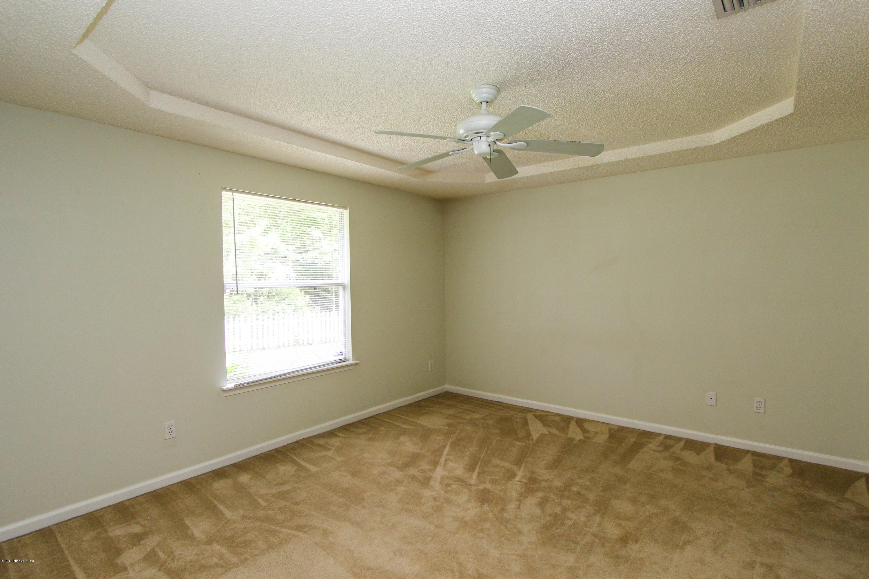 2750 Archer Street Middleburg, FL 32068 - Photo 23 of 34 an empty room with a window and ceiling fan