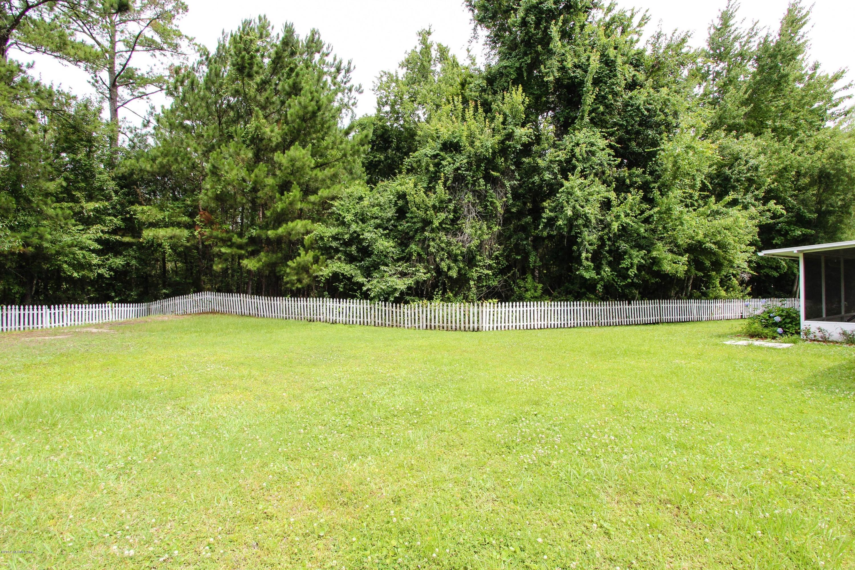 2750 Archer Street Middleburg, FL 32068 - Photo 30 of 34 a view of a swimming pool and trees in the background