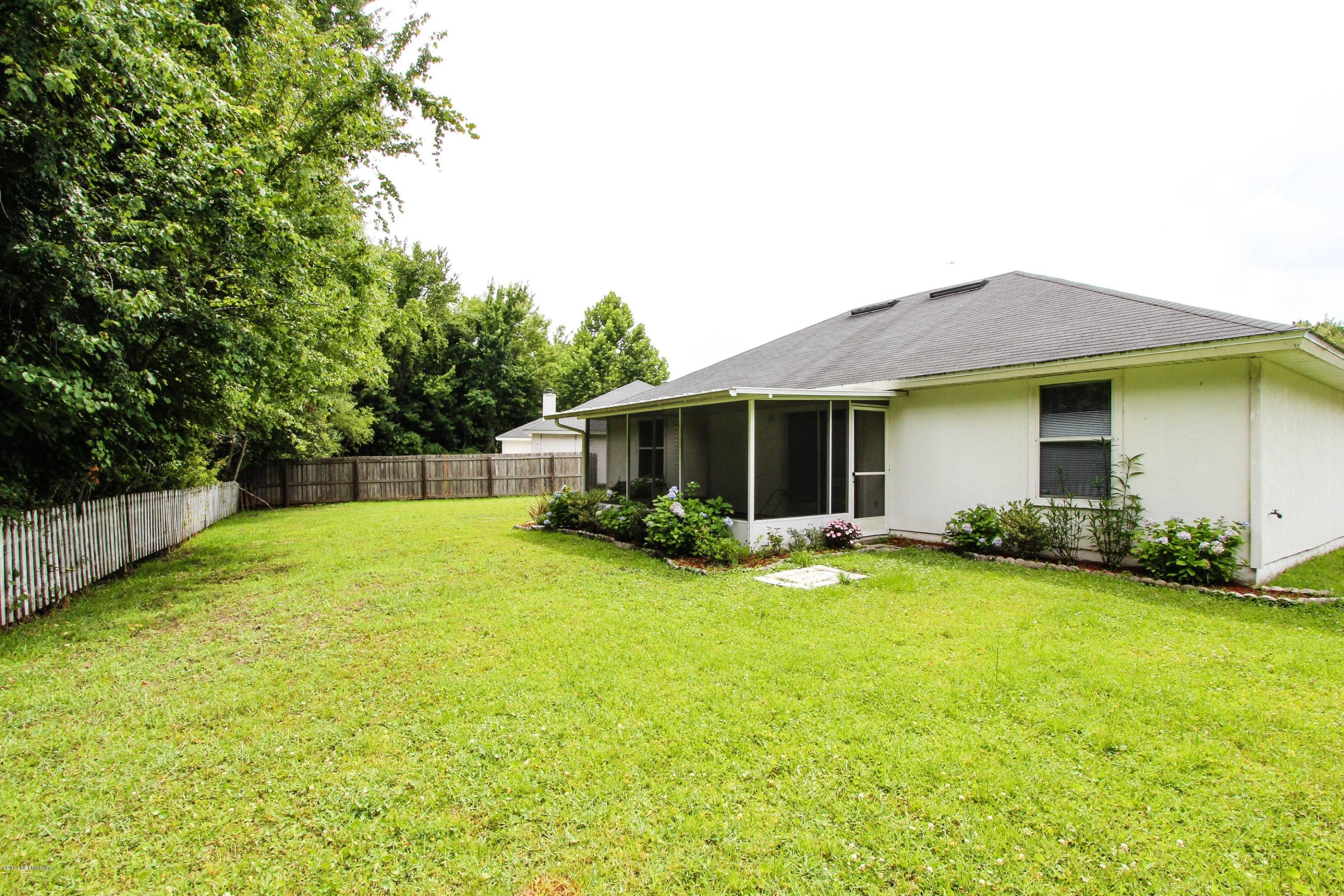 2750 Archer Street Middleburg, FL 32068 - Photo 31 of 34 a view of a house with a yard and sitting area