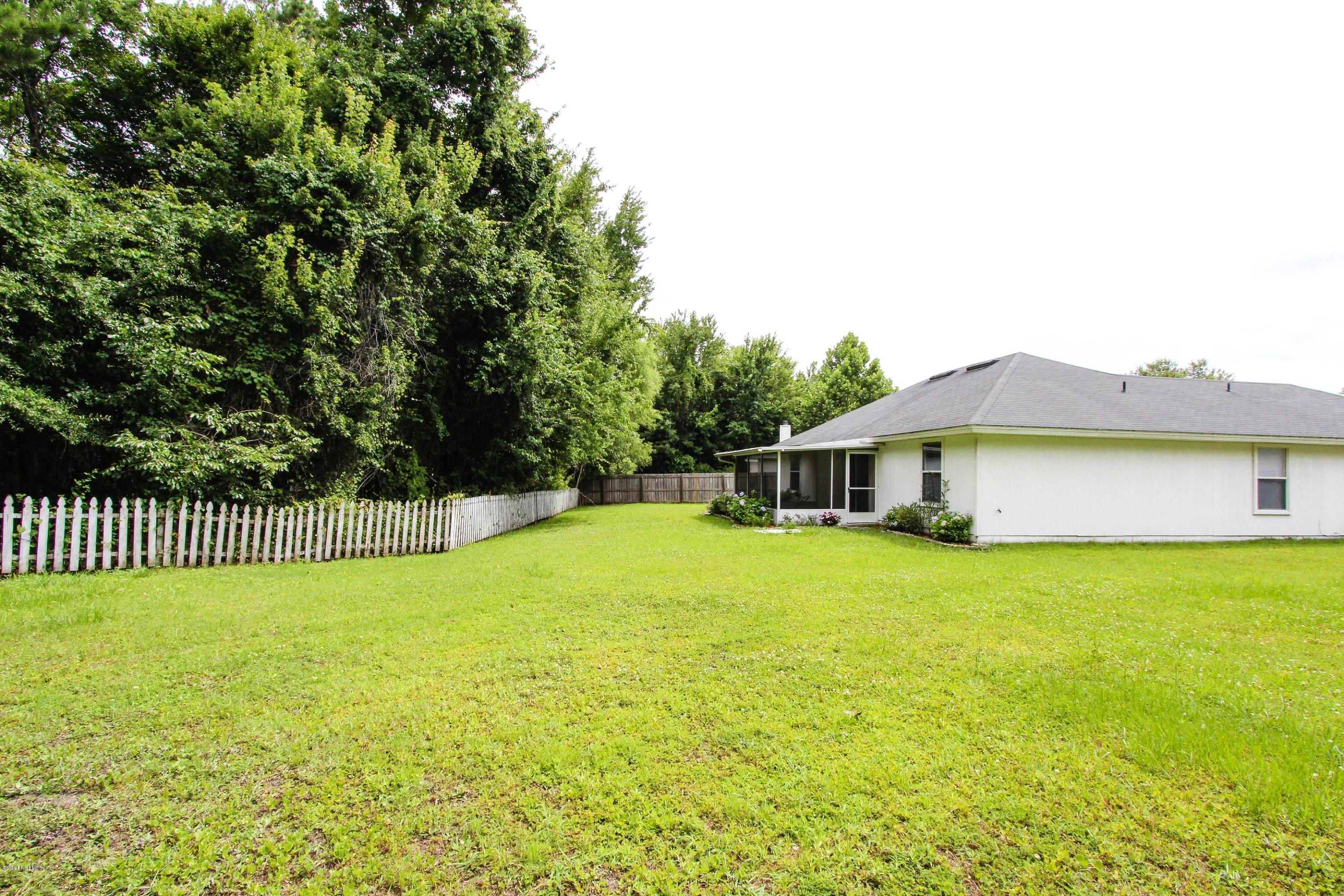 2750 Archer Street Middleburg, FL 32068 - Photo 32 of 34 a view of a house with a yard and a large tree