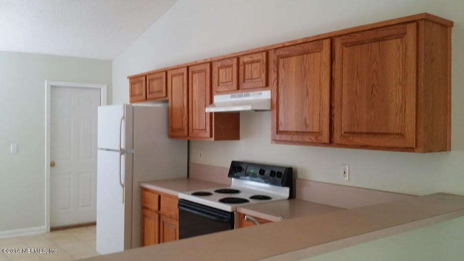 2750 Archer Street Middleburg, FL 32068 - Photo 6 of 34 a kitchen with stainless steel appliances granite countertop a refrigerator stove and cabinets