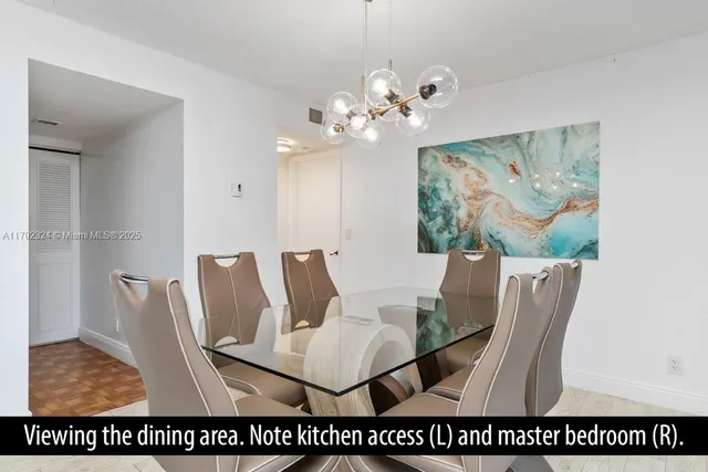 a view of a dining room with furniture and a chandelier