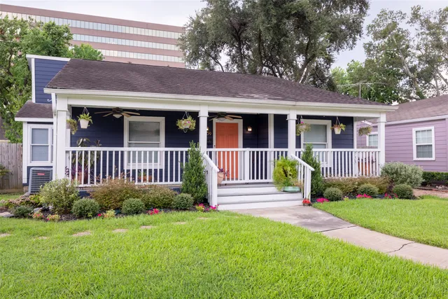 a view of a house with a yard and plants