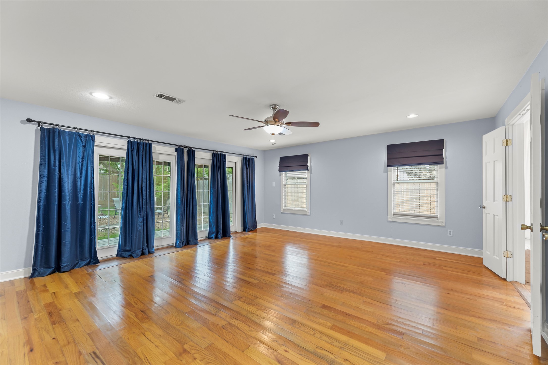 2209 Portsmouth Street Houston, TX 77098 - Photo 13 of 28 a view of an empty room with window and wooden floor