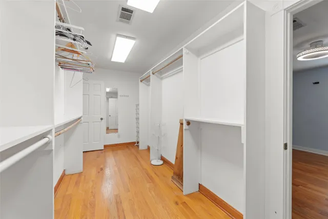 a view of an empty room with glass door and balcony