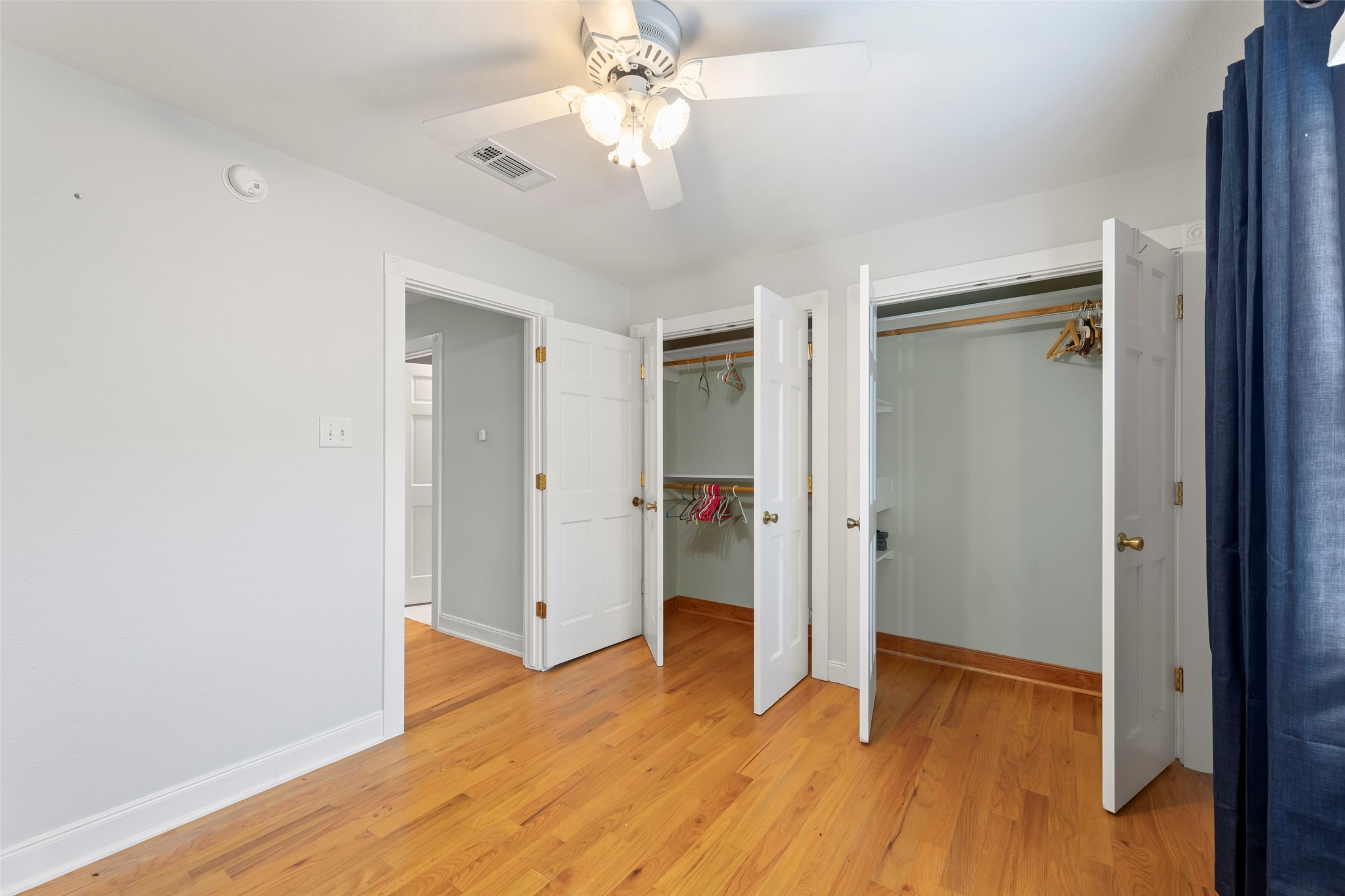 2209 Portsmouth Street Houston, TX 77098 - Photo 23 of 28 an empty room with wooden floor and ceiling fan