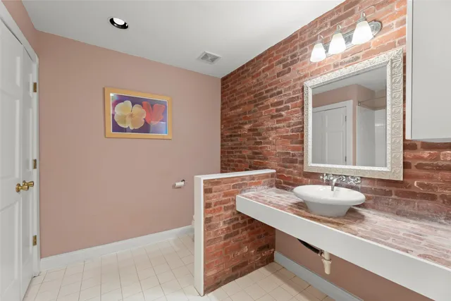 a bathroom with a tub sink and mirror