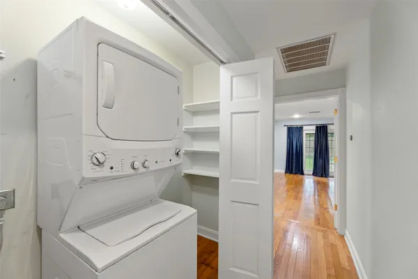 a front view of a house with a garden and trees