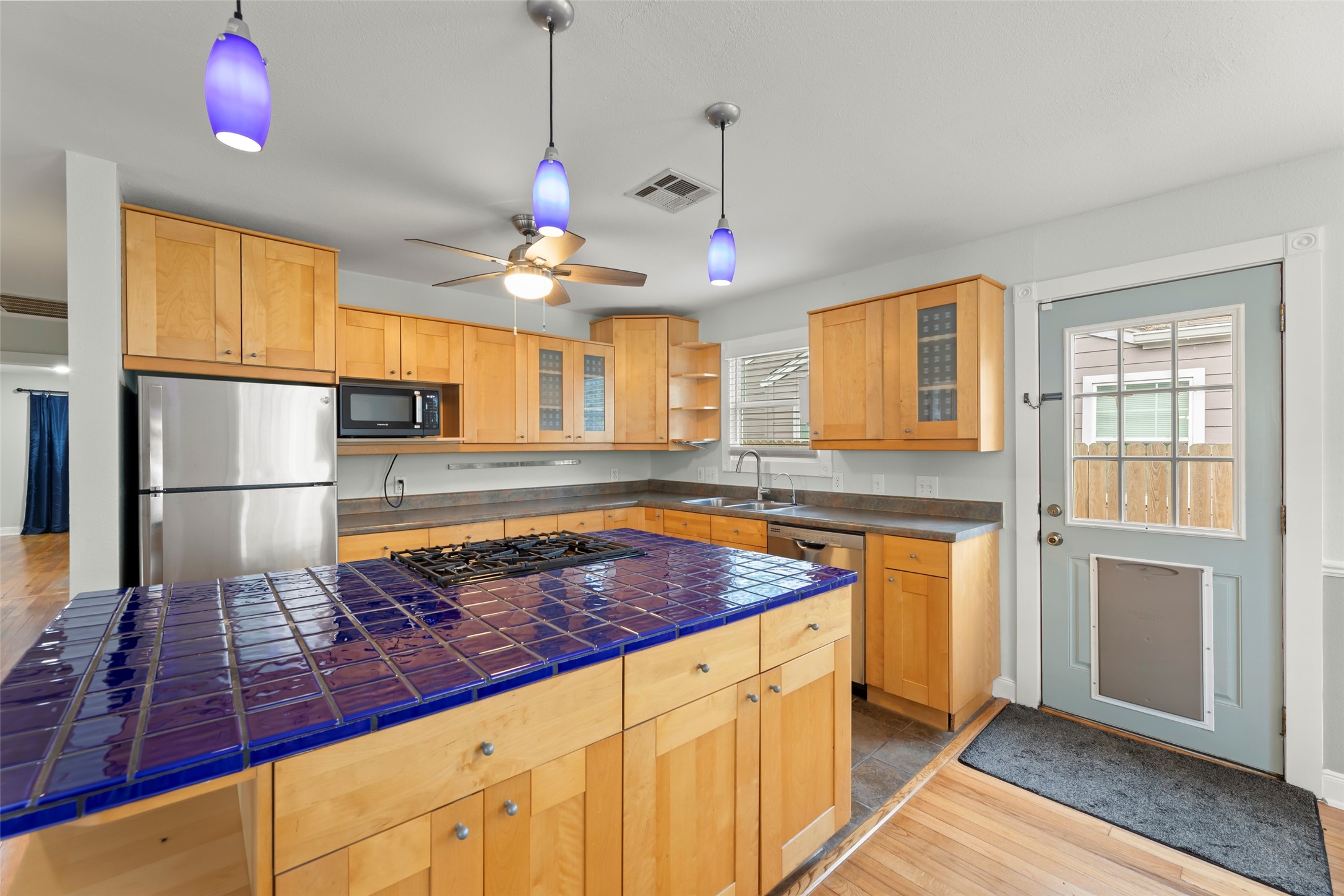 2209 Portsmouth Street Houston, TX 77098 - Photo 9 of 28 a kitchen with stainless steel appliances granite countertop a sink a stove and a refrigerator