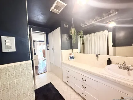 a bathroom with a sink a vanity and a mirror