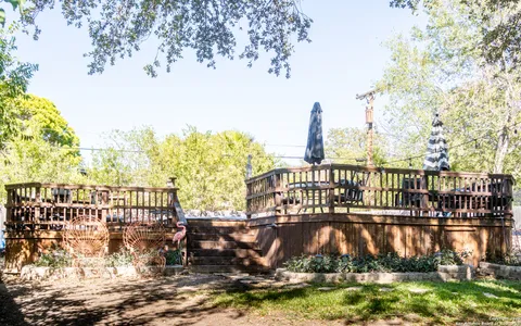 a view of a lake with boats and palm trees