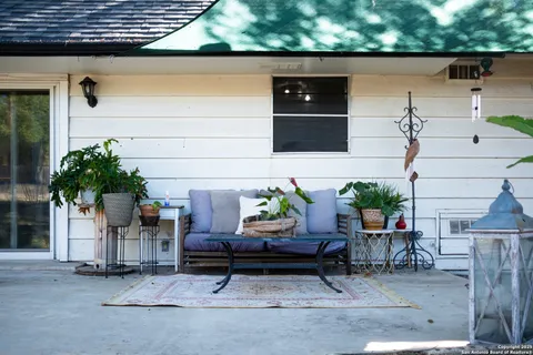 a backyard of a house with lots of green space and outdoor seating