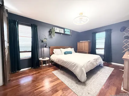 a bedroom with a bed lamp closet and window