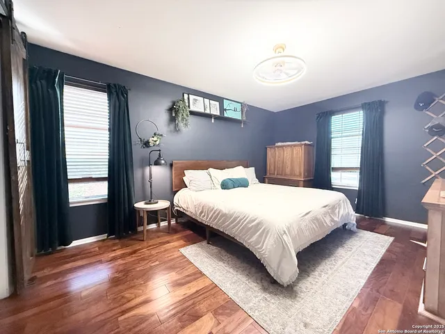 a bedroom with a bed lamp closet and window