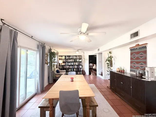 a large kitchen with a table and chairs