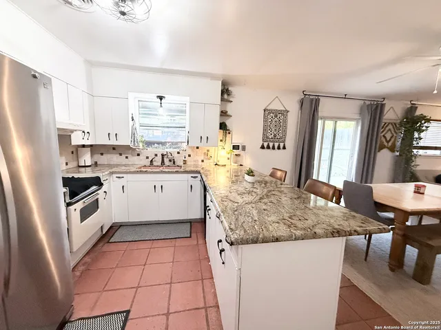 a kitchen with a stove a sink and a refrigerator