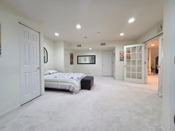 a spacious bedroom with a bed and a view of bathroom