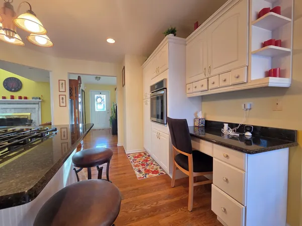 a kitchen with stainless steel appliances a stove a sink dishwasher and cabinets with wooden floor