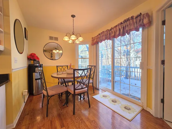 a view of a dining room with furniture chandelier and wooden floor