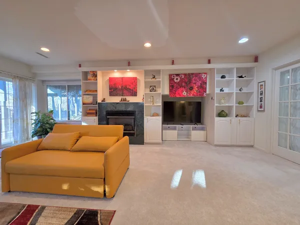 a bedroom with bed and a flat screen tv