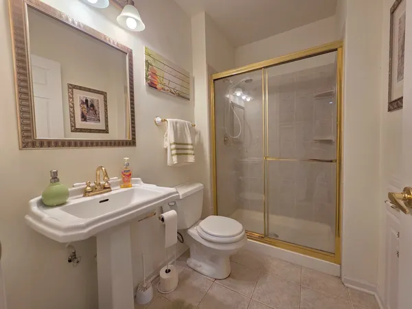 a bathroom with a sink mirror toilet and shower