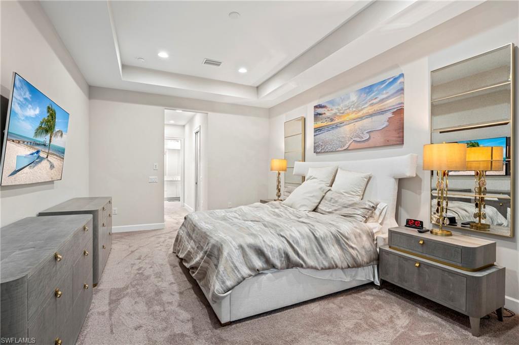 8795 Calypso Court Naples, FL 34113 - Photo 13 of 49 a bedroom with a bed and a painting on the wall
