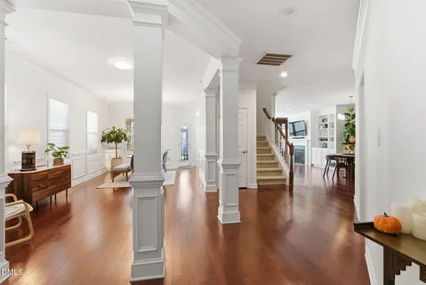 a living room with furniture a dining table and a wooden floor