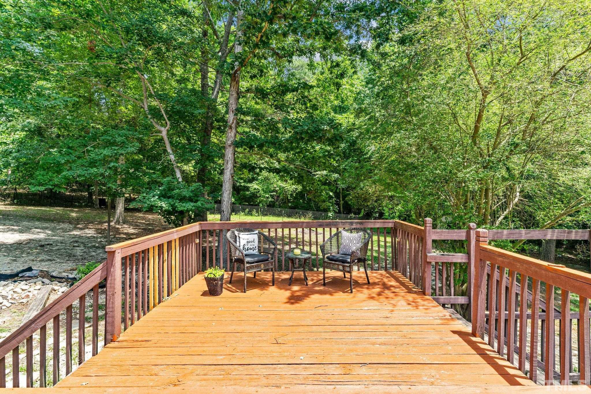 4209 Rockside Hills Drive Raleigh, NC 27603 - Photo 19 of 24 a balcony with wooden floor and yard in the back