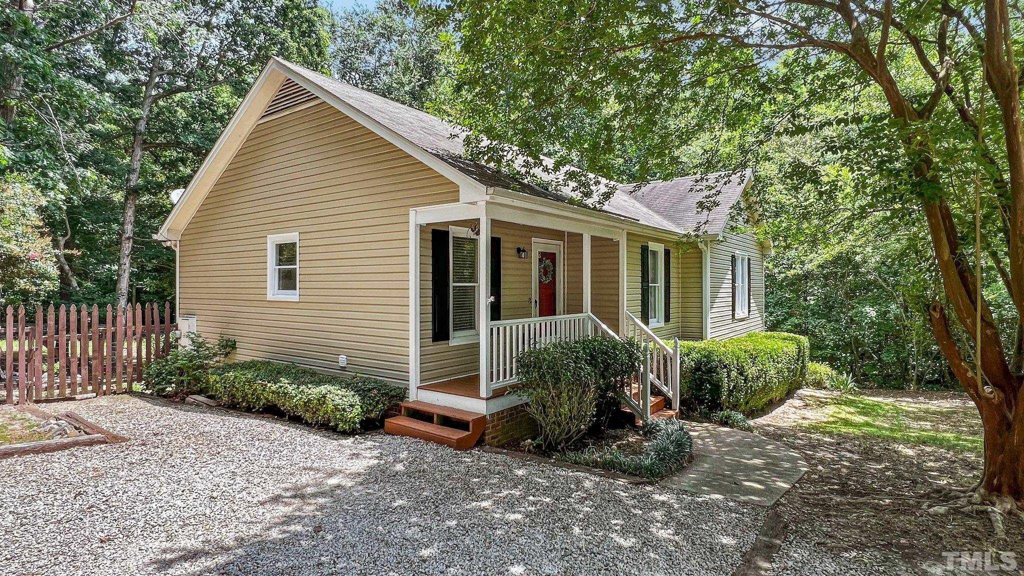4209 Rockside Hills Drive Raleigh, NC 27603 - Photo 2 of 24 a view of a house with backyard sitting area and garden