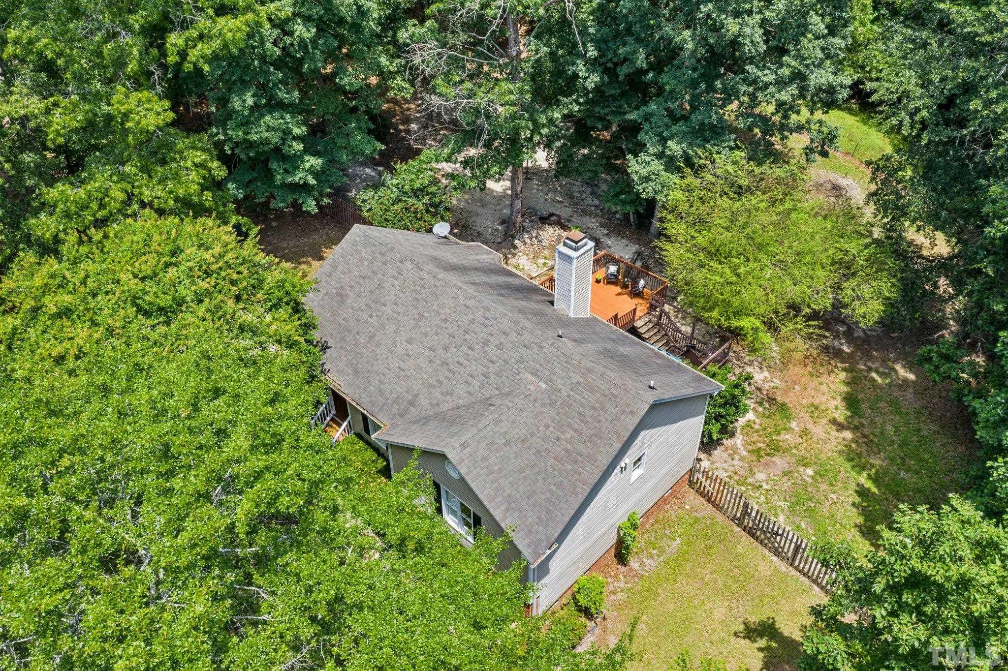 4209 Rockside Hills Drive Raleigh, NC 27603 - Photo 22 of 24 an aerial view of a house with a yard and trees all around