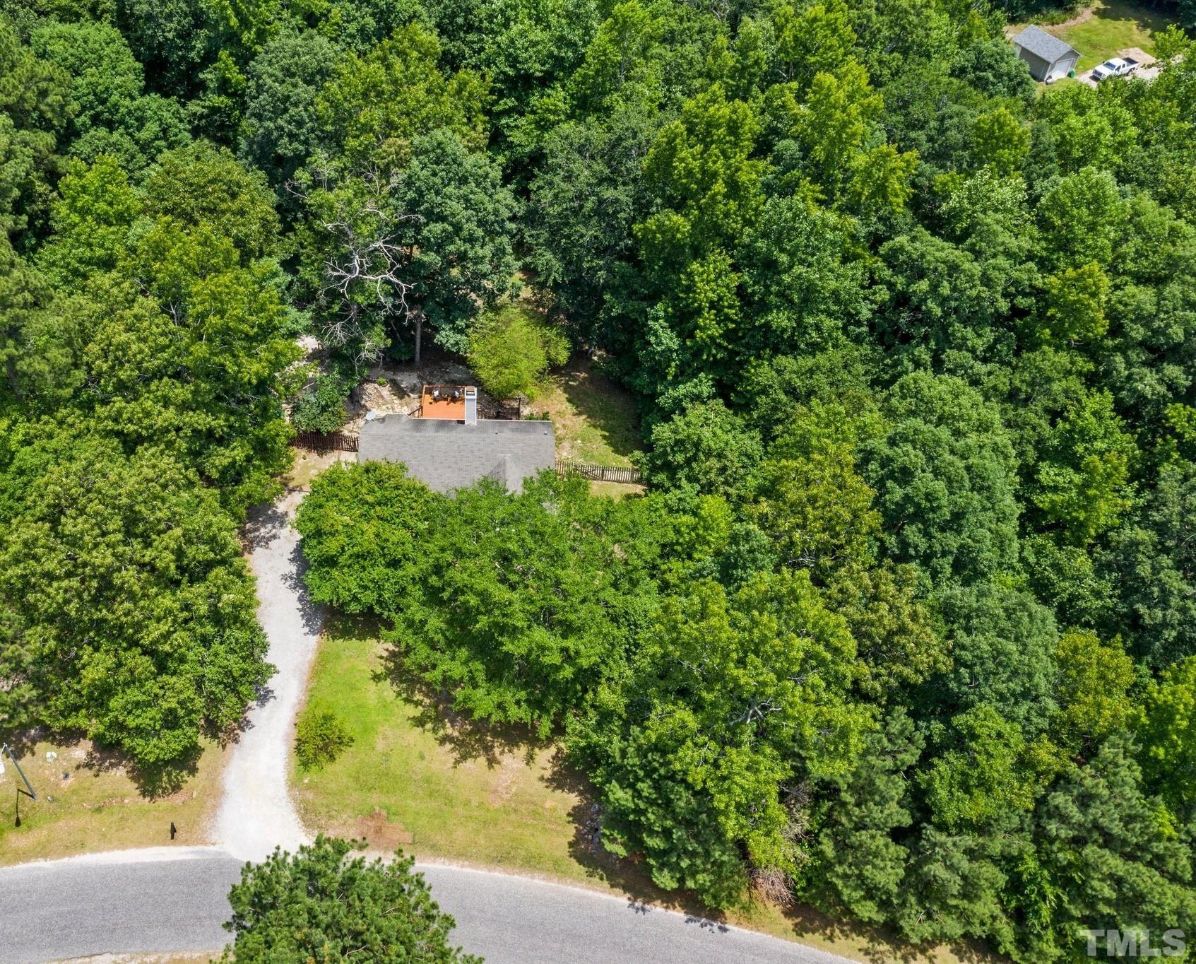 4209 Rockside Hills Drive Raleigh, NC 27603 - Photo 23 of 24 a backyard of a house with a yard and fountain