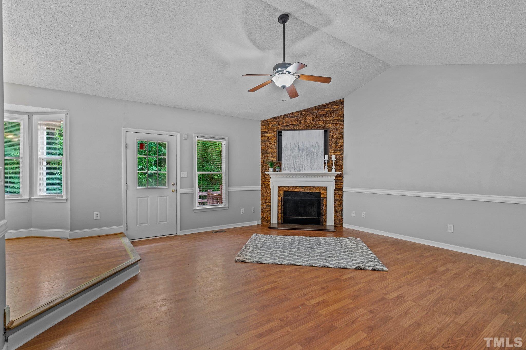4209 Rockside Hills Drive Raleigh, NC 27603 - Photo 4 of 24 a living room with furniture and a fireplace