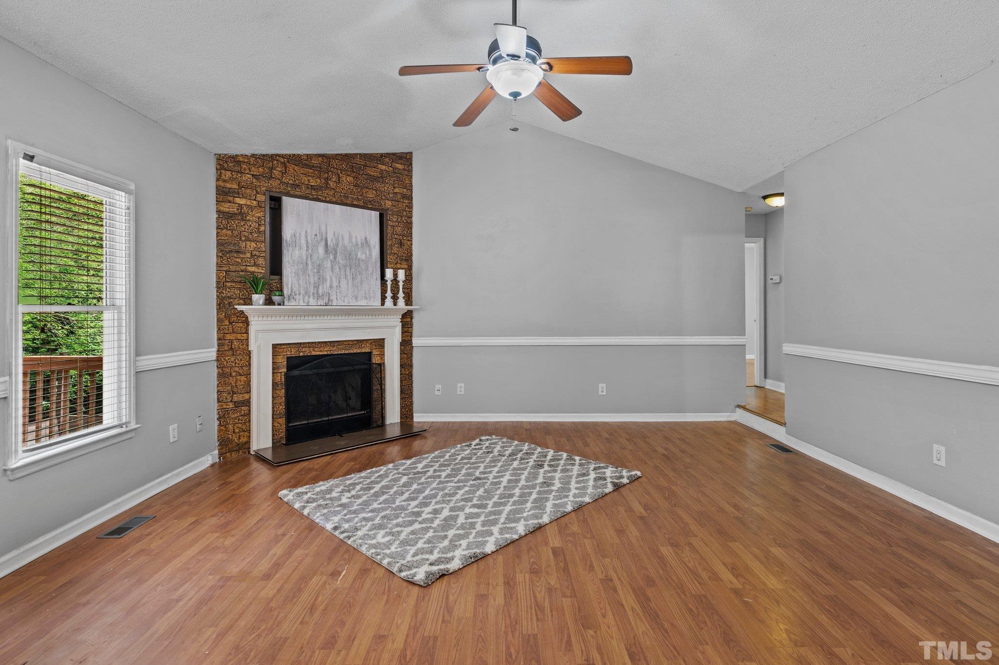 4209 Rockside Hills Drive Raleigh, NC 27603 - Photo 6 of 24 an empty room with windows and fireplace
