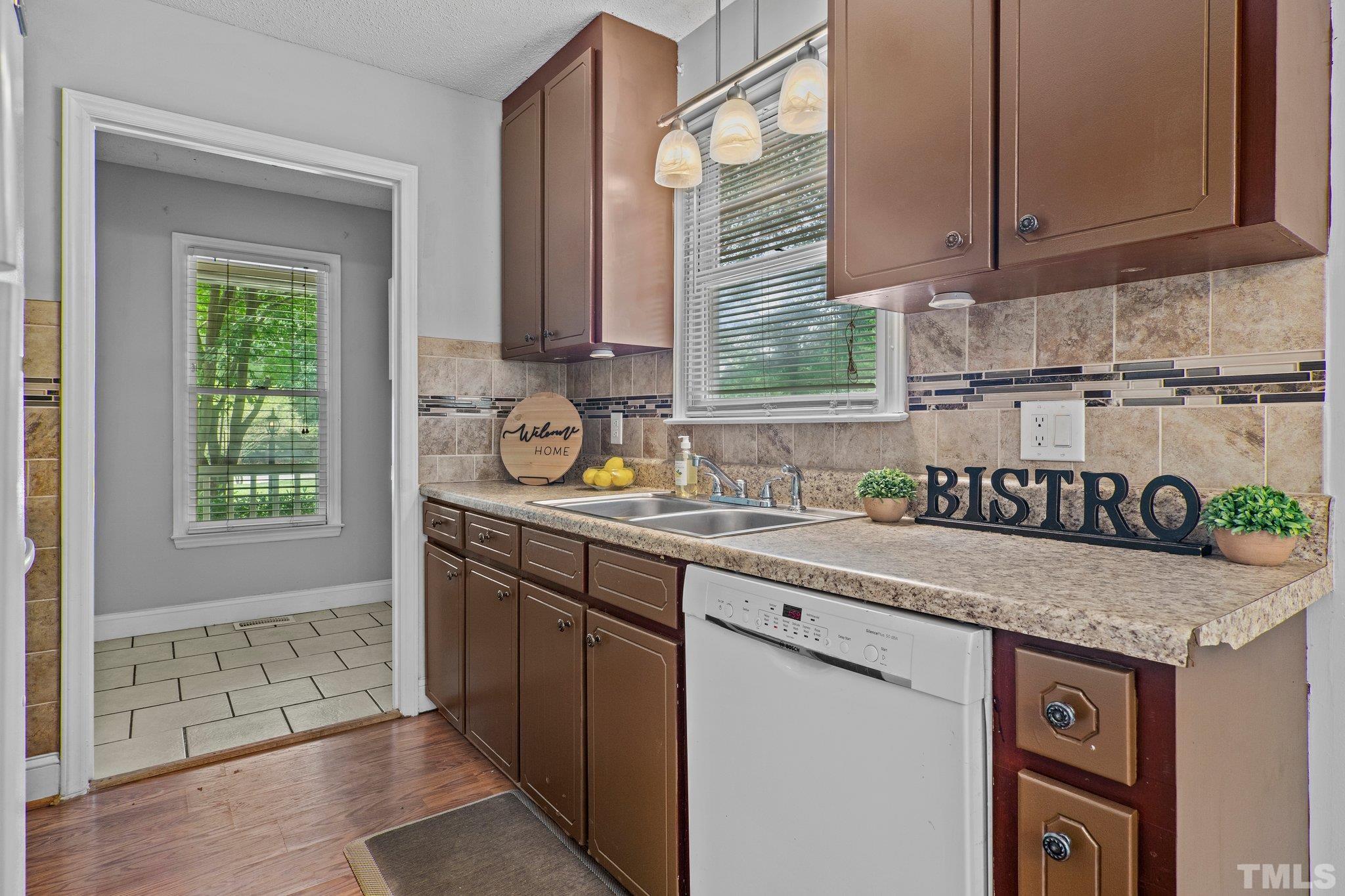 4209 Rockside Hills Drive Raleigh, NC 27603 - Photo 9 of 24 a kitchen with granite countertop a sink a stove and cabinets