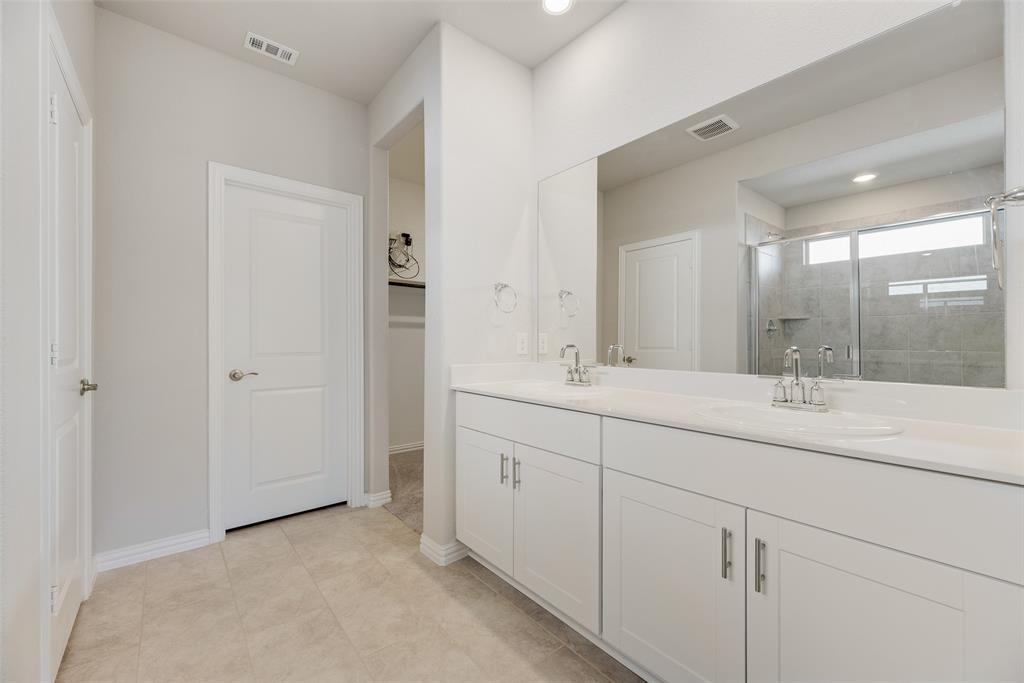 203 Rocky Road Melissa, TX 75454 - Photo 17 of 27 a bathroom with double sink and a mirror