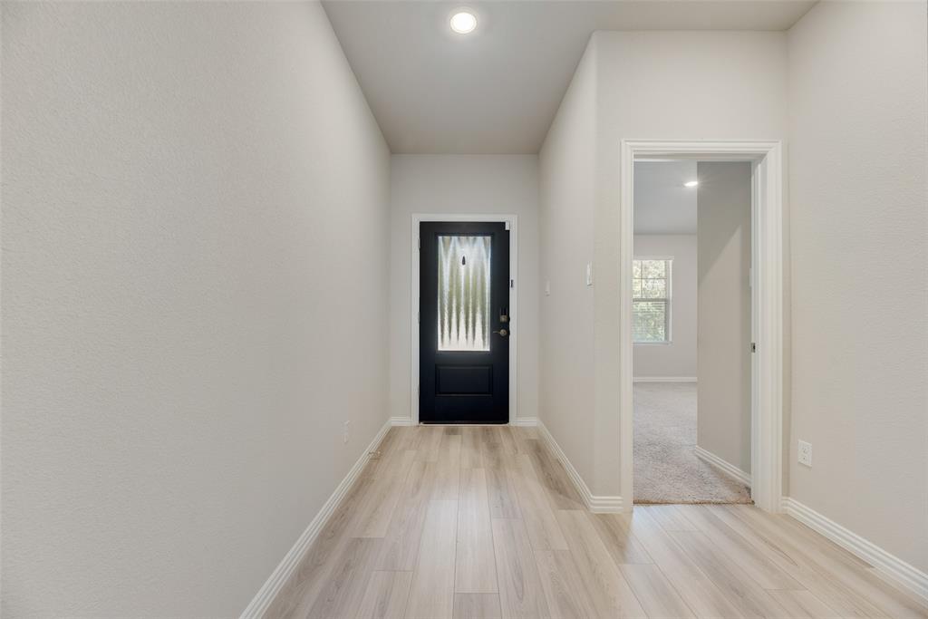 203 Rocky Road Melissa, TX 75454 - Photo 2 of 27 a view of a hallway with wooden floor