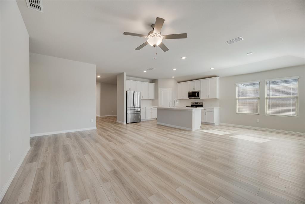 203 Rocky Road Melissa, TX 75454 - Photo 5 of 27 a view of an empty room with wooden floor and a window