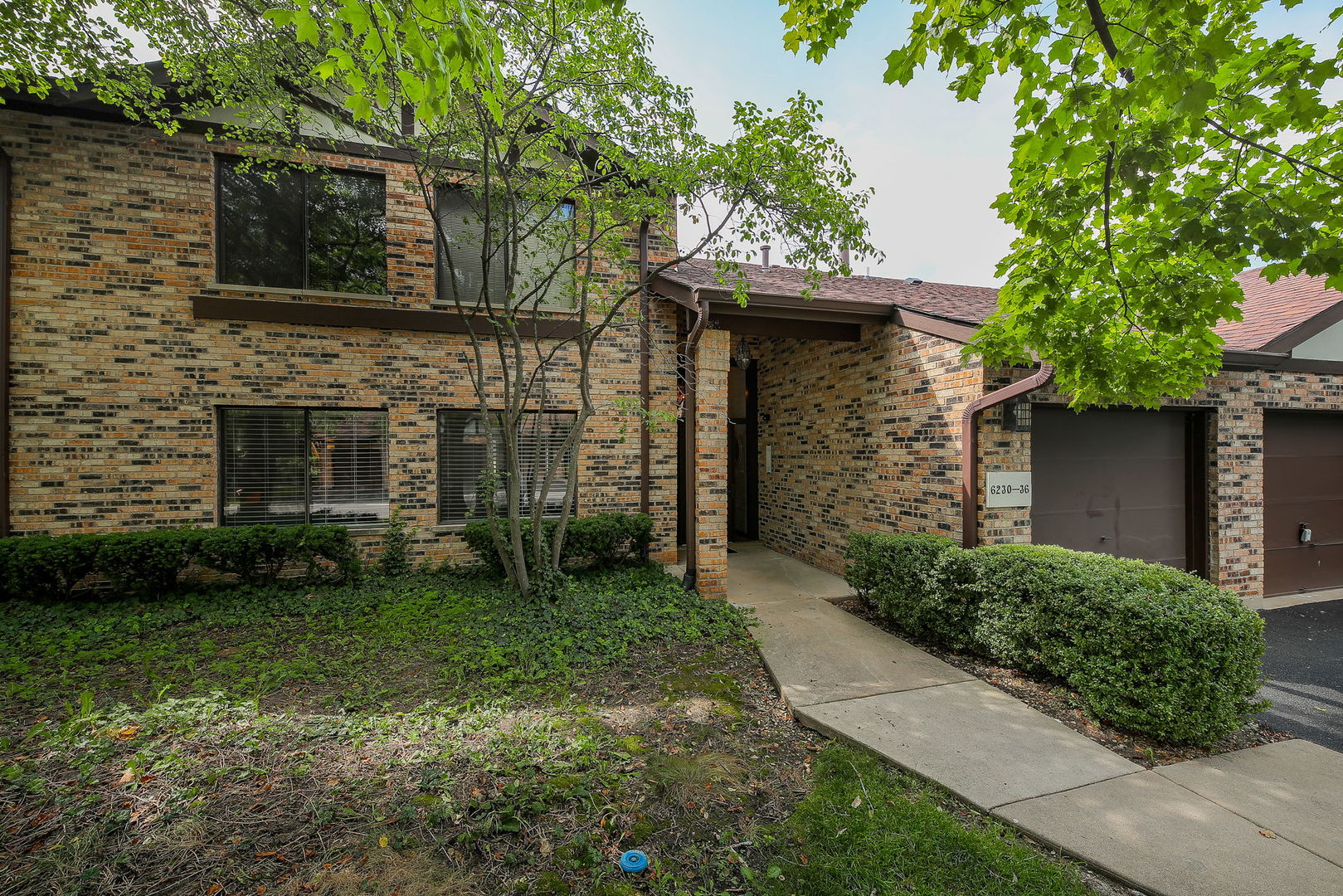 6230 Trinity Drive, Unit 1C Lisle, IL 60532 - Photo 1 of 27 a front view of a house with garden