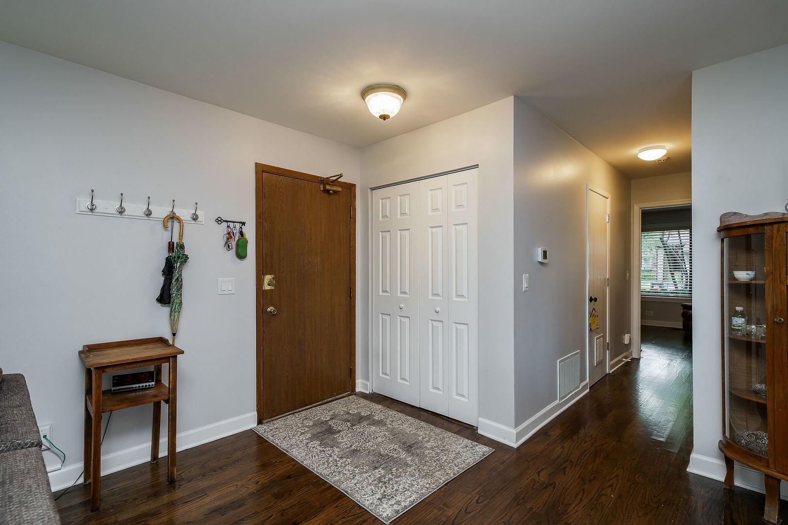 6230 Trinity Drive, Unit 1C Lisle, IL 60532 - Photo 12 of 27 a view of livingroom with hardwood floor and hallway