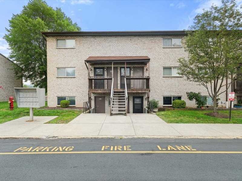 26 Cooper Road, Unit 306 Poughkeepsie, NY 12603 - Photo 1 of 16 a front view of a house with a yard and garage