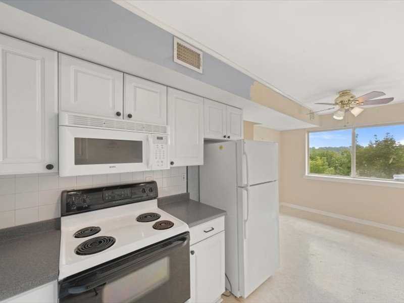 26 Cooper Road, Unit 306 Poughkeepsie, NY 12603 - Photo 12 of 16 a kitchen with a stove and a refrigerator